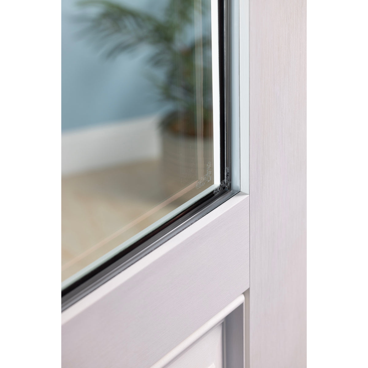 Close-up of the flush glazed glass edge on a white Satin Smooth fiberglass door