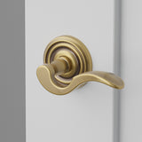Cortina Lever Interior Lockset with Regular Rosette by Emtek, Antique Brass, right handed