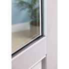 Close-up of the flush glazed glass edge on a white Satin Smooth fiberglass door