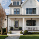 Full lite flush glazed fiberglass entry door with Rill glass on a white farmhouse with a covered front porch