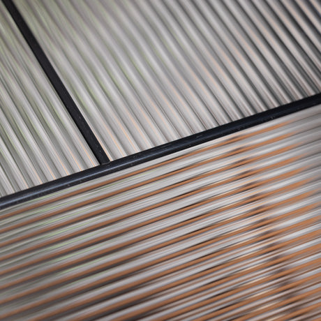 Close-up of Rill textured privacy glass with fine reeded lines and black caming