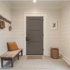Gray 3 panel Shaker fiberglass door in an entry hall with a bench